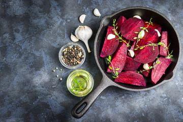 Raw beetroot with balsamic, garlic and spices in cast iron skillet. Top view.