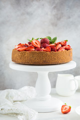 cheesecake  with fresh strawberry on white cake stand