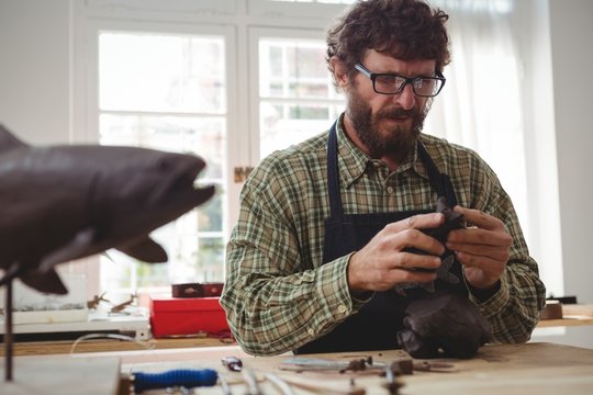 Craftsman working on clay sculpture
