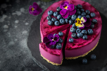 no baked blueberry mousse cake on dark background