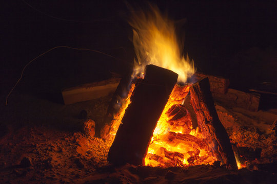 Hot fireplace full of wood and fire burning