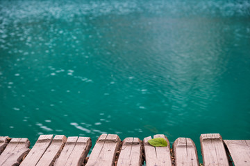 Old wooden pier above turquoise water