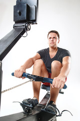 Fototapeta na wymiar Man Using A Press Machine In A Fitness Club.