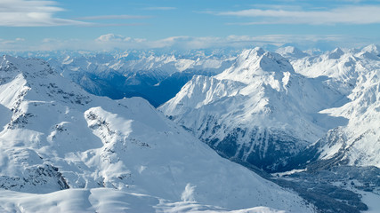 Winter mountain valley sunny panoramic view from Corvatsch peak of the Lower Engadine, in the...