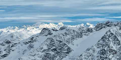Fototapeta na wymiar Winter snowy mountain panoramic view from Corvatsch peak of the Lower Engadine, in the Switzerland.