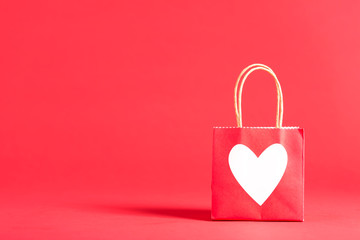Gift bag with heart on a red background