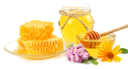 Honeycomb with honey dipper and honey isolated on white background