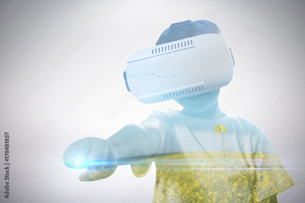 Poster Composite image of boy clenching fist while using virtual