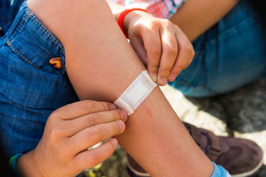 Child Sticking Plaster On Leg