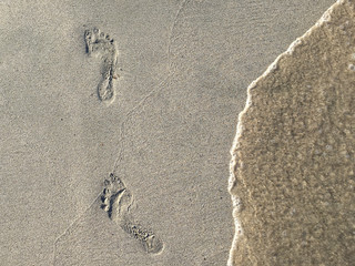 Foot Steps Prints On Ocean Beach Sand