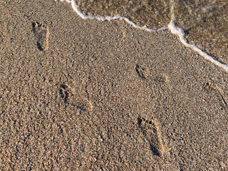 Foot Steps Prints On Ocean Beach Sand