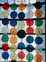 Fototapeta na wymiar Colorful Umbrellas Hanging In Sky