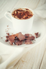 Mug of cocoa and chocolate on a plate