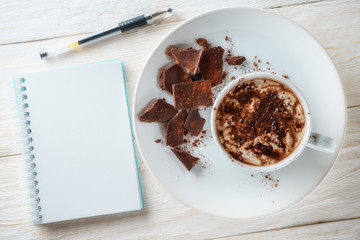 Notepad and a cup of hot cocoa