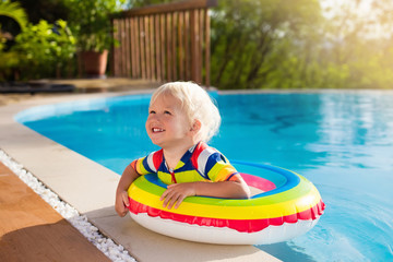 Baby in swimming pool. Kids swim. Child summer fun.