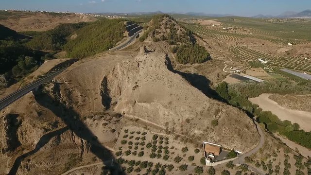 1080p Aerial, Flight over a highway bridge and down river village and olive orchards, Andalucia, Spain. Staright rows of olive trees and high rise bridge with going on cars. Way to Cordoba