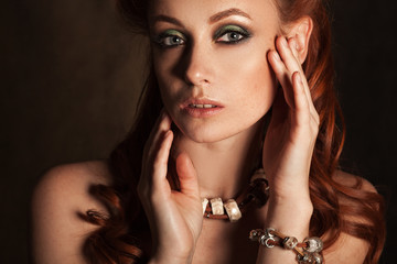 Beauty portrait of a beautiful redhead girl with bright make-up