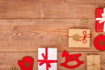 christmas background with decorations and gift boxes on wooden table, top view, copyspace