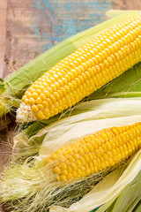 Fresh corn on rustic wooden table, closeup