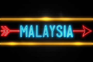 Malaysia  - fluorescent Neon Sign on brickwall Front view