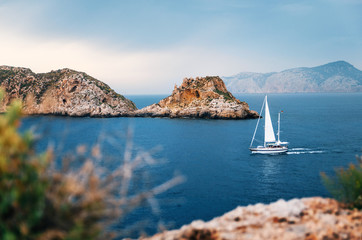 Sailboat with german flag are sailing at Mediterranean sea between cliffs and rocks against the stormy sky, Santa Ponsa, Mallorca, Spain - 170489097
