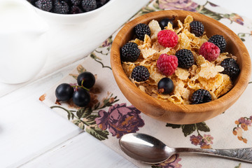  Breakfast with muesli and berries,  bowl of corn flakes with berries and milk