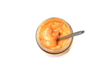 cheese sauce in a jar on a white background