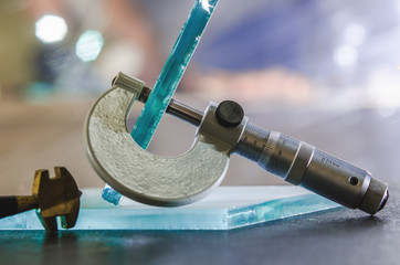 micrometer measures the thickness of the glass