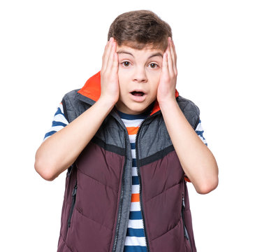 Half-length emotional portrait of caucasian teen boy. Surprised teenager looking at camera. Handsome child, isolated on white background.