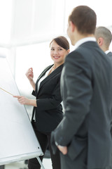 Successful businesswoman in suit at the office leading a group