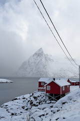 Tourist rorbuer-traditional fishing cottages-Olstinden mount across the Reinefjorden. Hamnoy-Reine-Moskenesoya-Lofoten-Norway. 0374