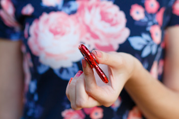 A girl is holding a popular toy fidget spinner in her hands. Stress relief. Anti stress and...