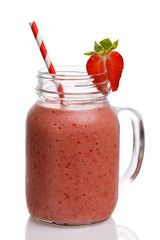 Strawberry smoothies with banana and orange juice in a glass jar on a white background