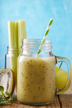 Freshly prepared smoothies from apples, kiwi and celery, close-up