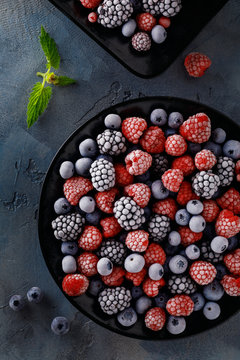 Frozen juicy and ripe berries of blueberries, blackberries and raspberries, top view. Home Harvest