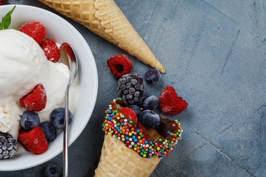 Vanilla ice cream with fresh frozen berries raspberries, blueberries and blackberries with space for text