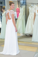 women choosing wedding dress in shop