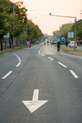 Empty street without traffic with arrow road sign