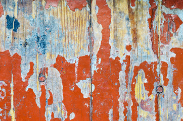 Texture of old dilapidated wooden floor with red peeling paint. Exfoliated Paint on an Old Wooden Floor