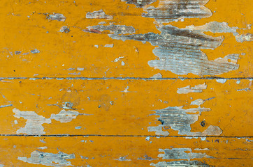 Texture of old dilapidated wooden floor with yellow peeling paint. Exfoliated Paint on an Old...