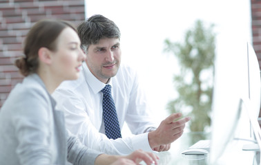 Manager and assistant work with a PC
