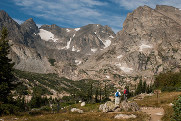 Fototapeta na wymiar Two athletic hikers climb a mountain in the high altitude of Colorado