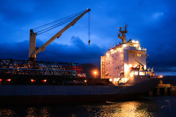 Ship and Crane with lights at Evening time