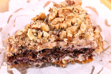 portion of white and brown chocolate walnut cake with walnuts
