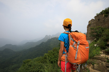 young woman hiker hiking on great wall