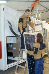 two electrical workers checking rv solar cell panel