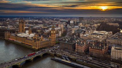 Fototapeta na wymiar London, England - Aerial skyline view of the Big Ben and Houses of Parliament, Westminster Bridge with red double decker buses, St Margaret's Church, St James's Park and Buckingham Palace at sunset