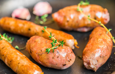Grilled barbecue chorizo meat sausages in a frying pan