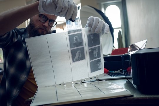 Photographer putting negatives in folder