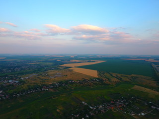 Aerial view of beautiful village, houses, roads. Sky, clouds.